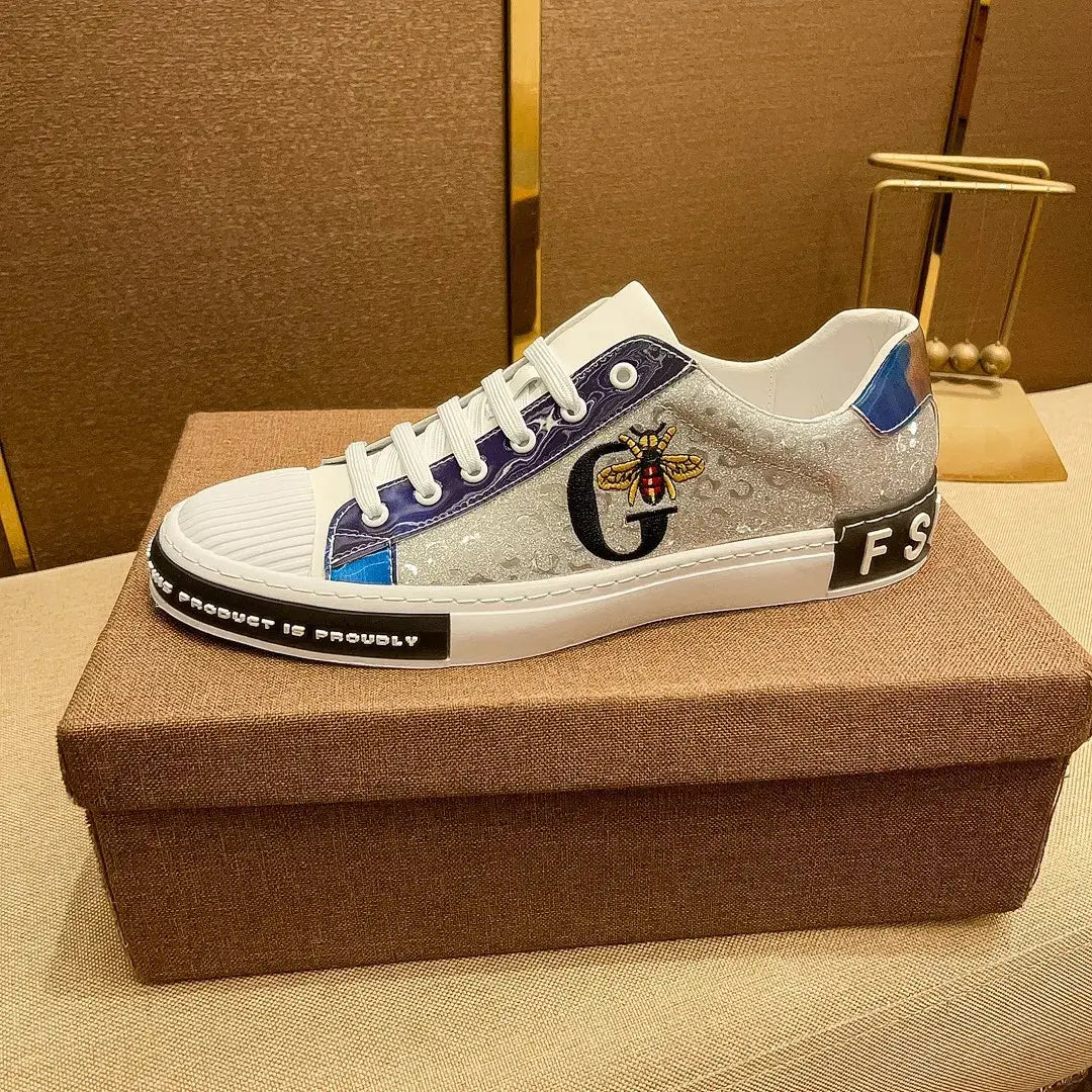 Designer sneaker in metallic silver with blue accents and G logo for classic sneakers.