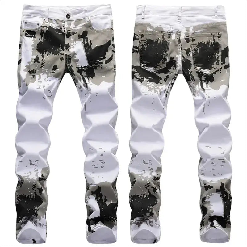 Pair of white jeans with abstract black paint splatters and patterns.