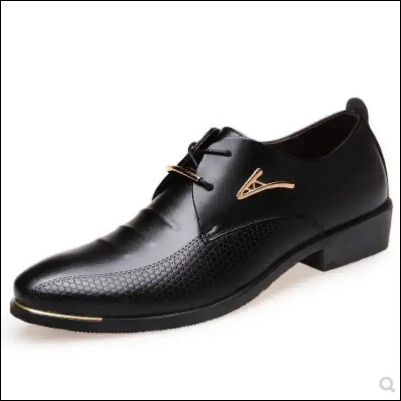 Black leather dress shoe with a pointed toe and decorative metal accent.