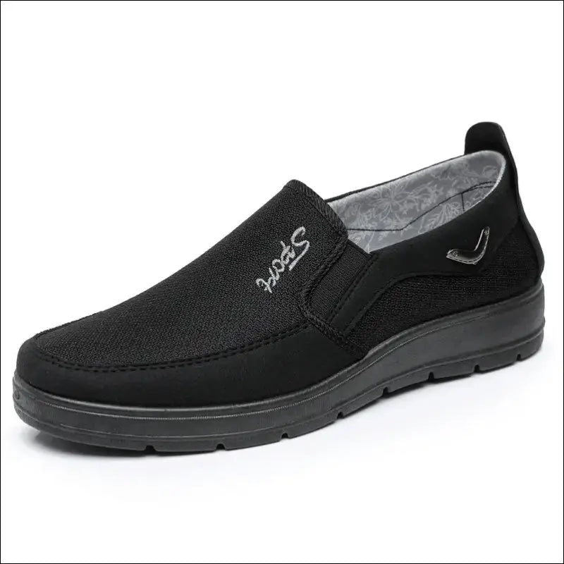 Black slip-on casual shoe with a flat sole and fabric upper.