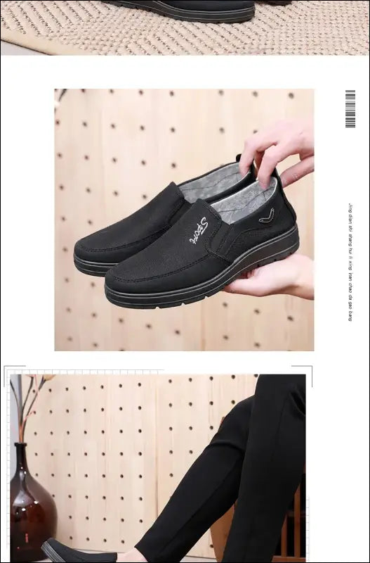 Black slip-on shoe being held by a hand.