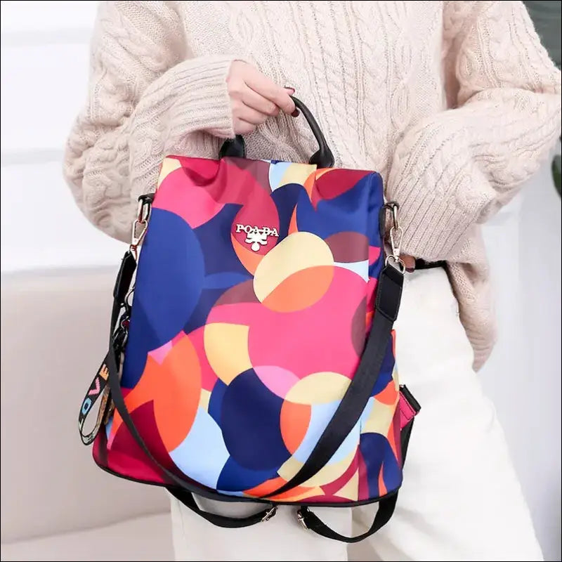 Colorful, abstract-patterned backpack with multiple straps.