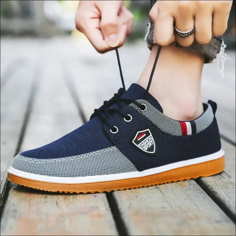 Navy blue casual sneaker with gray accents and a gum sole.