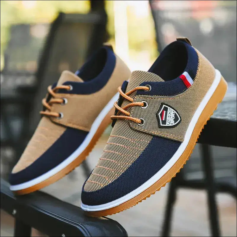 Casual canvas sneaker with a multi-colored design featuring beige, navy, and tan tones.