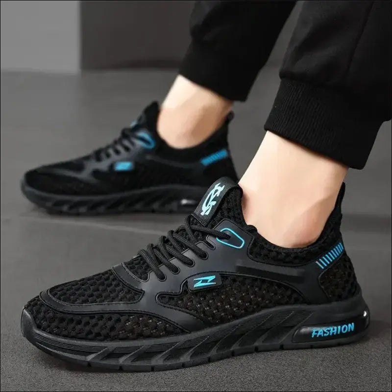 Black athletic sneaker with blue accents and mesh detailing.