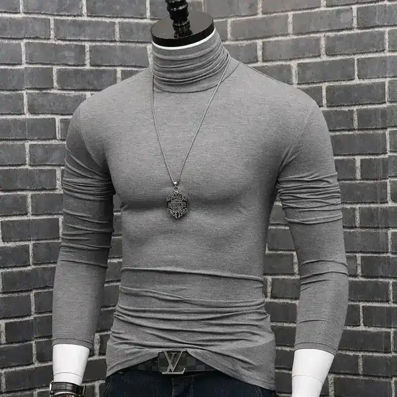 Gray turtleneck sweater with a pendant necklace on a mannequin torso.