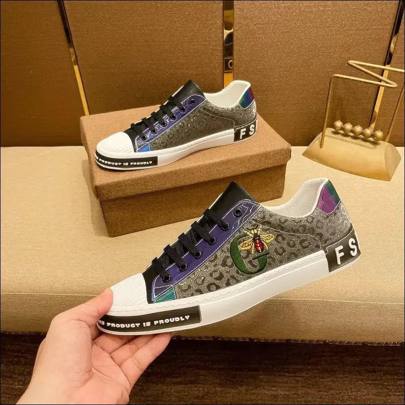 Designer sneaker with a patterned upper, colorful accents, and a bee embroidery.