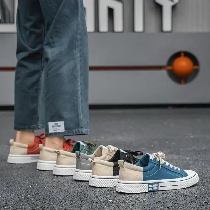 Row of colorful sneakers in various styles and colors arranged on a floor.