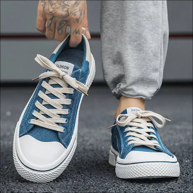 Blue canvas sneakers with white laces and rubber soles.