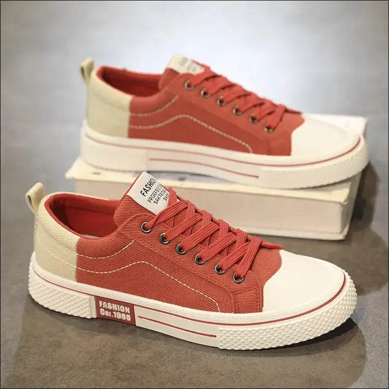 Pair of casual red canvas sneakers with white soles and laces.