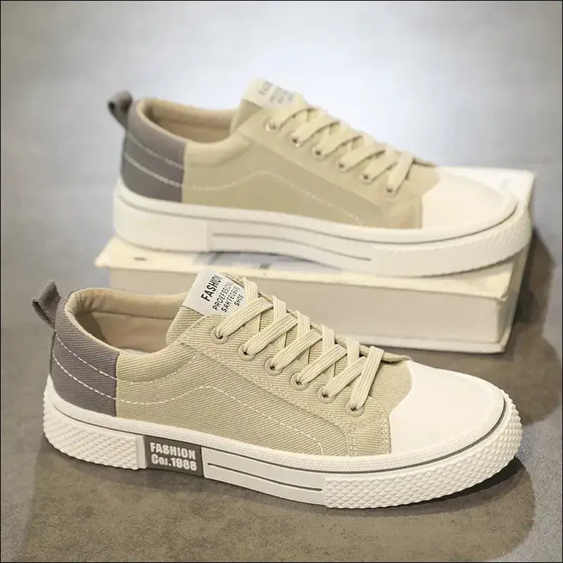 Pair of beige canvas sneakers with white soles and gray heel accents.