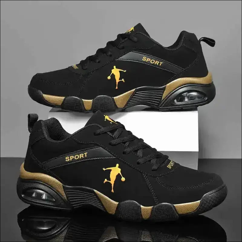 Black and gold athletic sneakers with a basketball player silhouette logo.