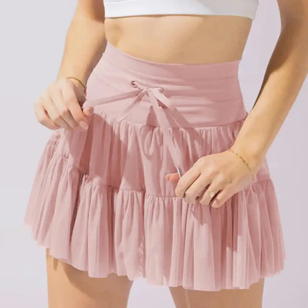 Pink ruffled mini skirt with a drawstring waist.