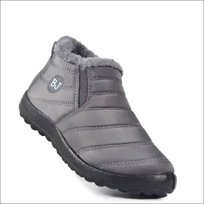 Gray quilted slip-on shoe with a black rubber sole.