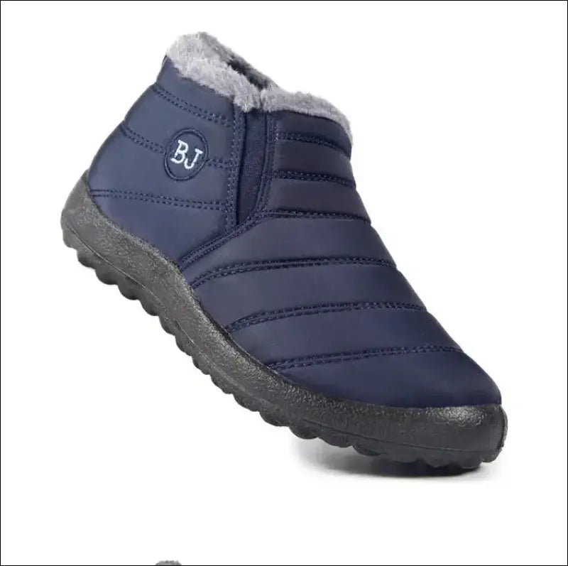 Navy blue slip-on winter boot with quilted fabric upper and rubber sole.