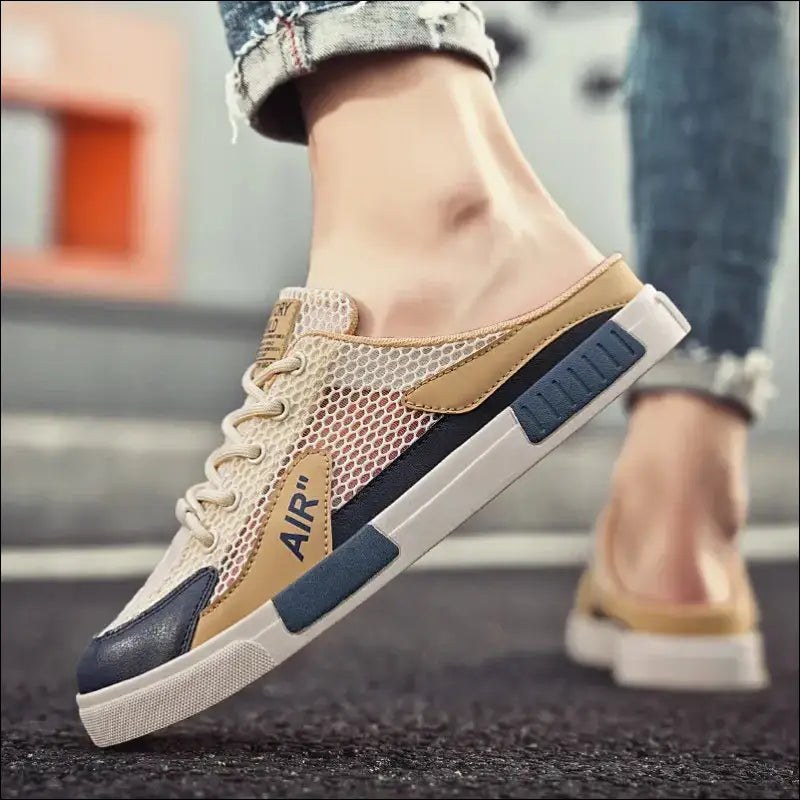 Stylish sneaker with a mix of beige, blue, and white colors featuring mesh and leather materials.