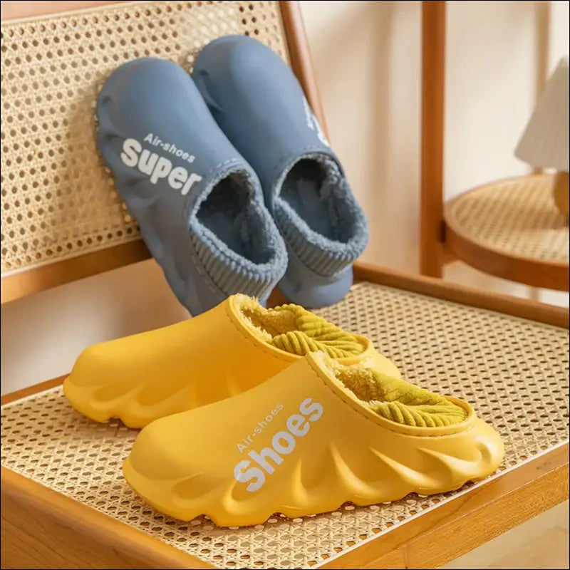 Colorful foam slippers in blue and yellow with text printed on them.