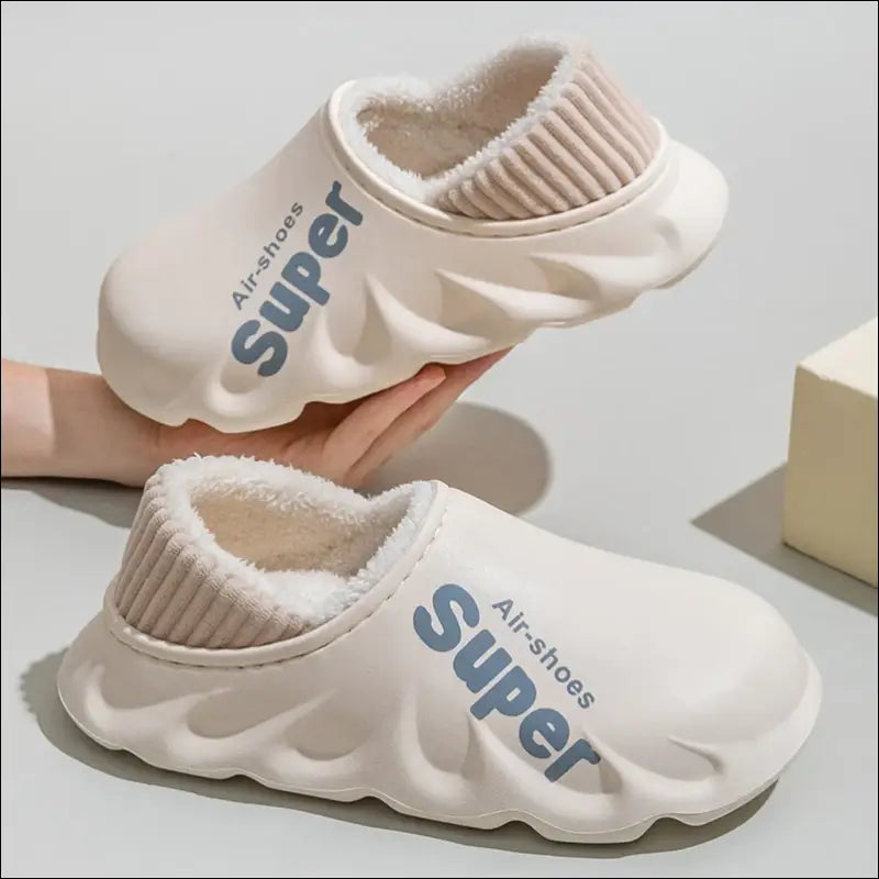 Pair of white foam slip-on shoes with ’Super’ branding and fuzzy lining.