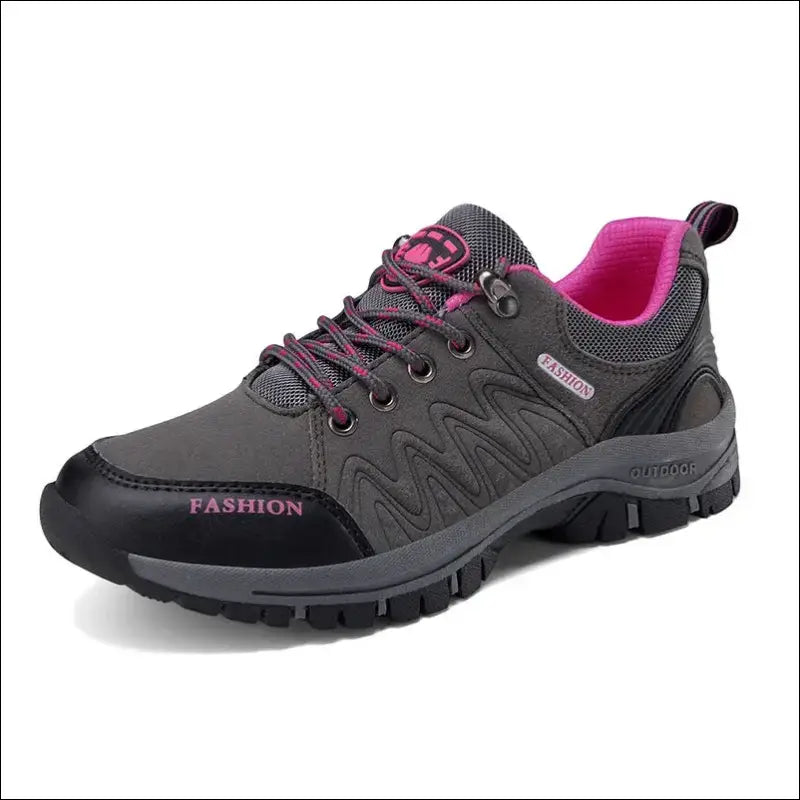 Gray and pink athletic hiking shoe with rugged tread.