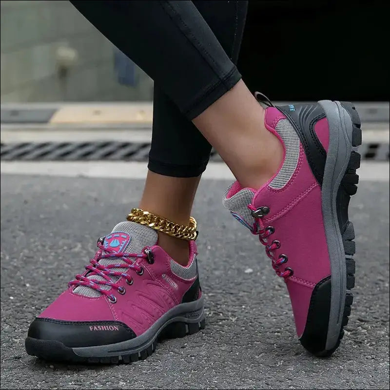 Bright pink hiking or trail running shoes with gray accents and laces.